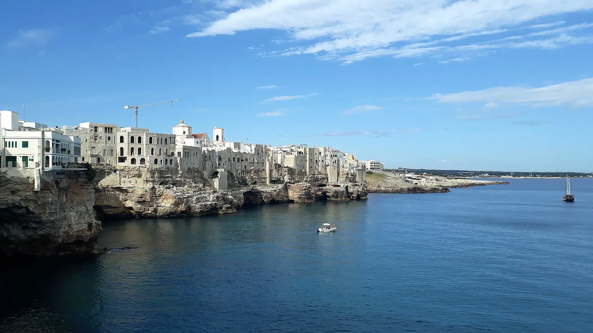Panoramic view of Polignano a Mare on the dramatic Puglia coastline, with white buildings perched on cliffs above the turquoise Adriatic